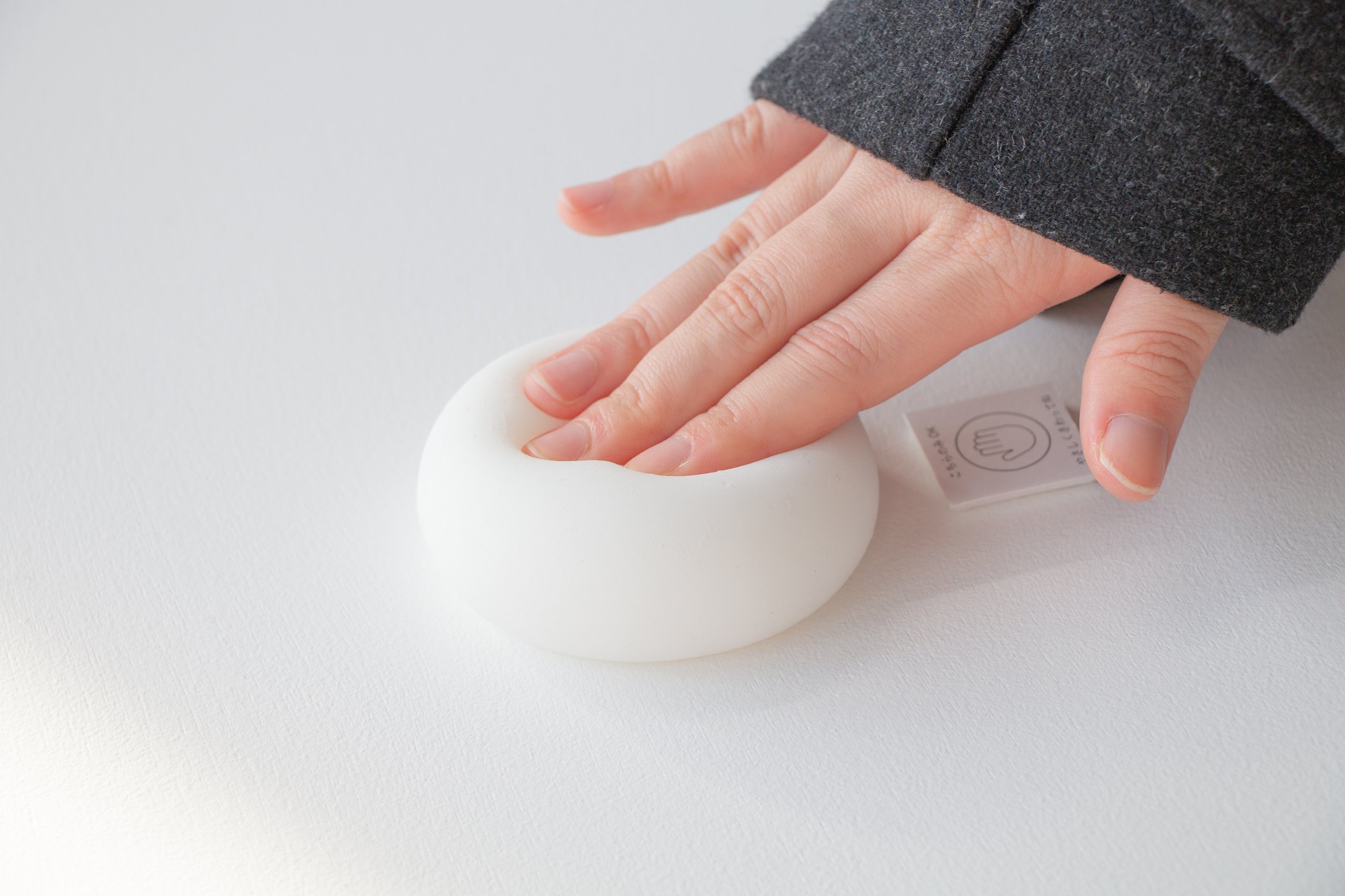 展示風景の写真。柔らかい球体を手で押している